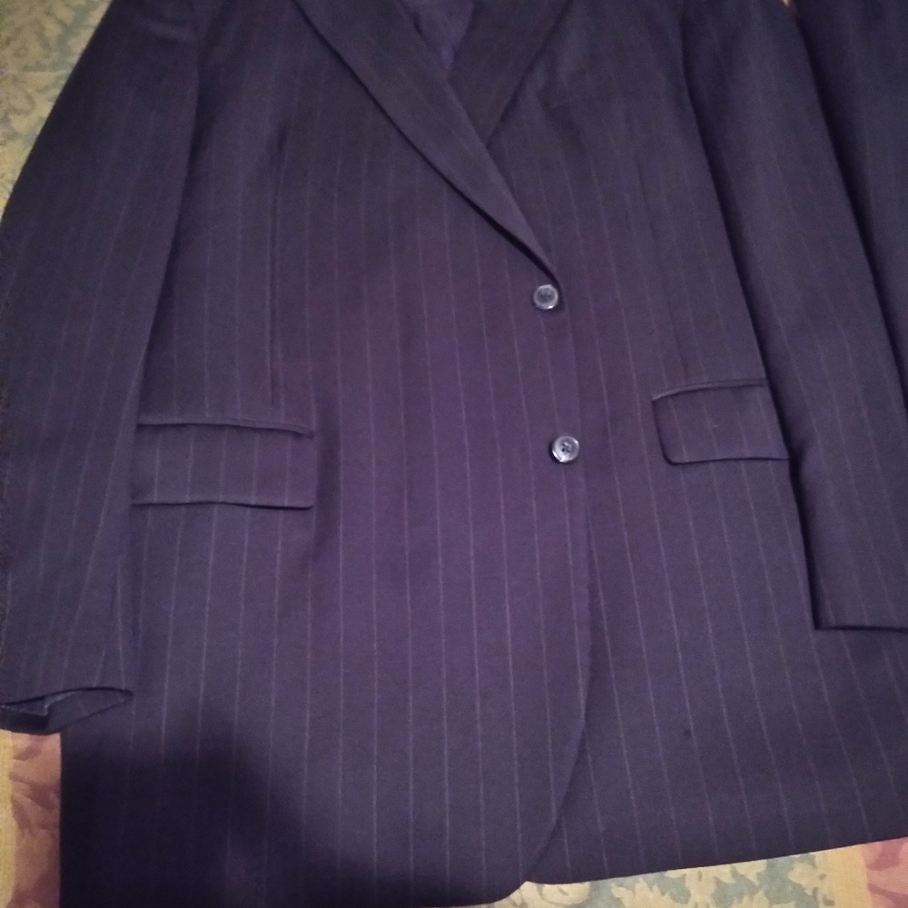 A Black Pinstripe 2 Button Suit. 50L 44/32. Pants are Pleated w Cuff